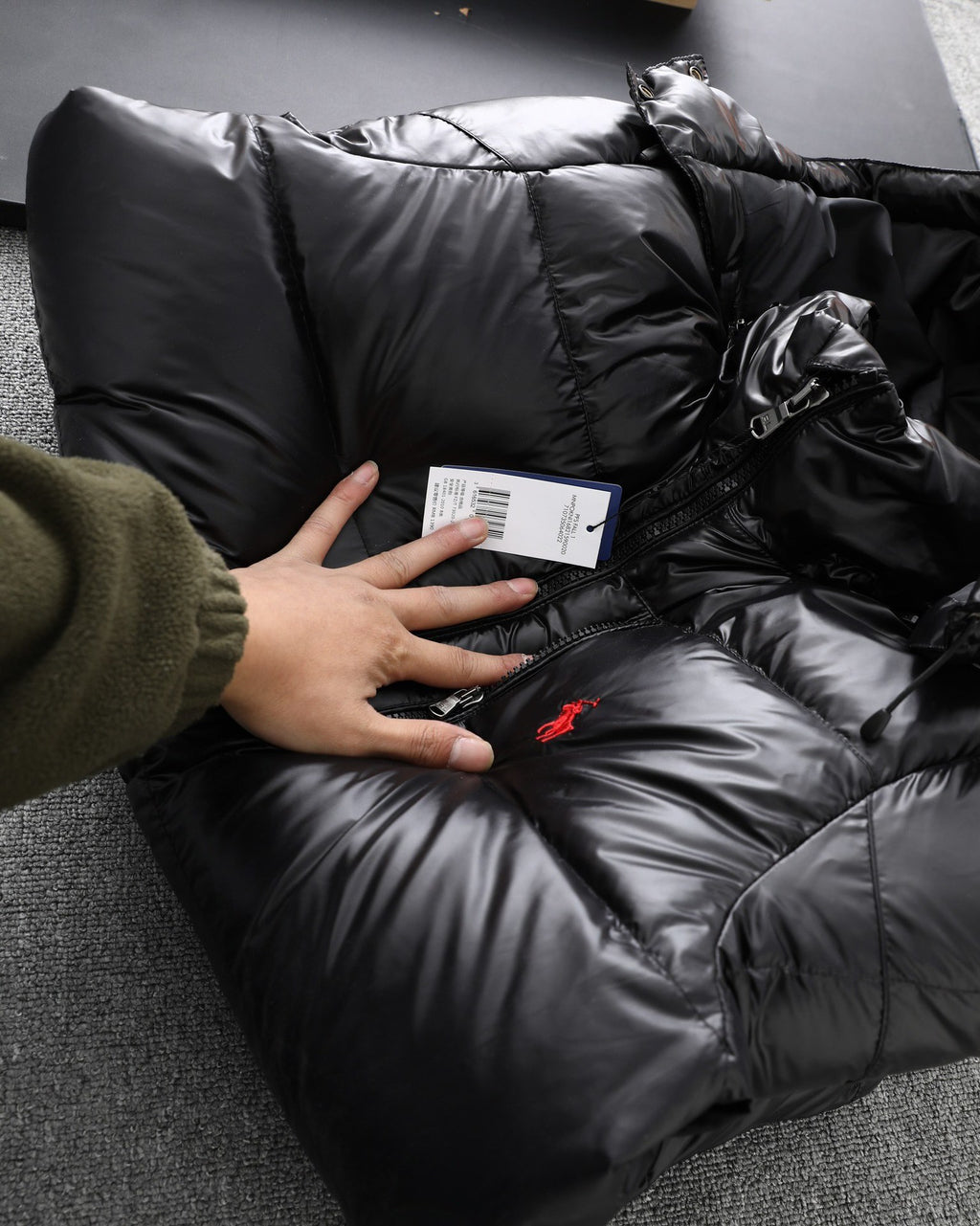 Black shiny Polo puffer jacket close-up