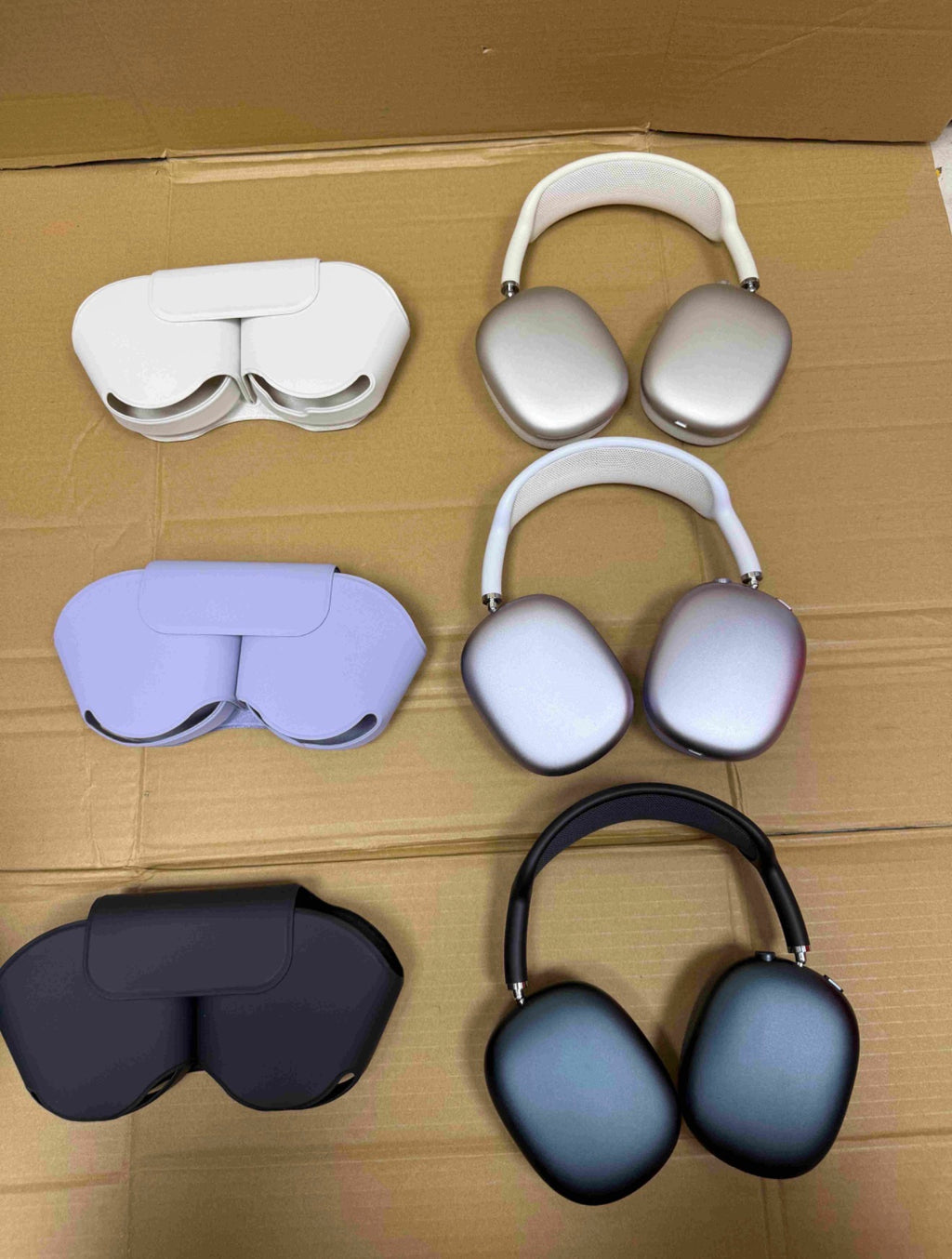 Light AirPods Max headphones beside a phone showing pairing