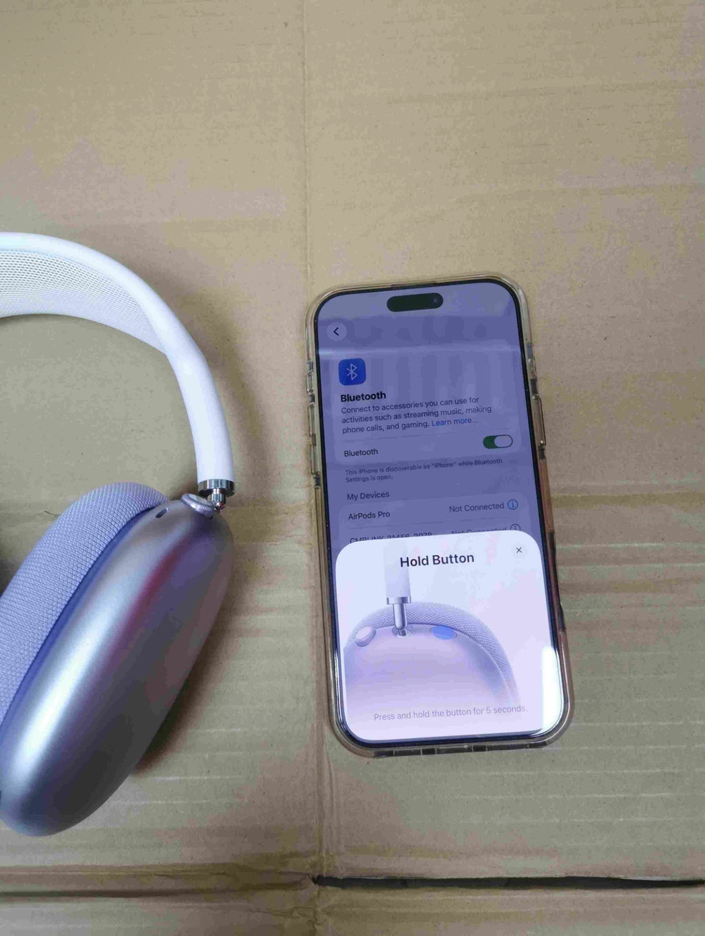 Black AirPods Max headphones and carrying case from the front