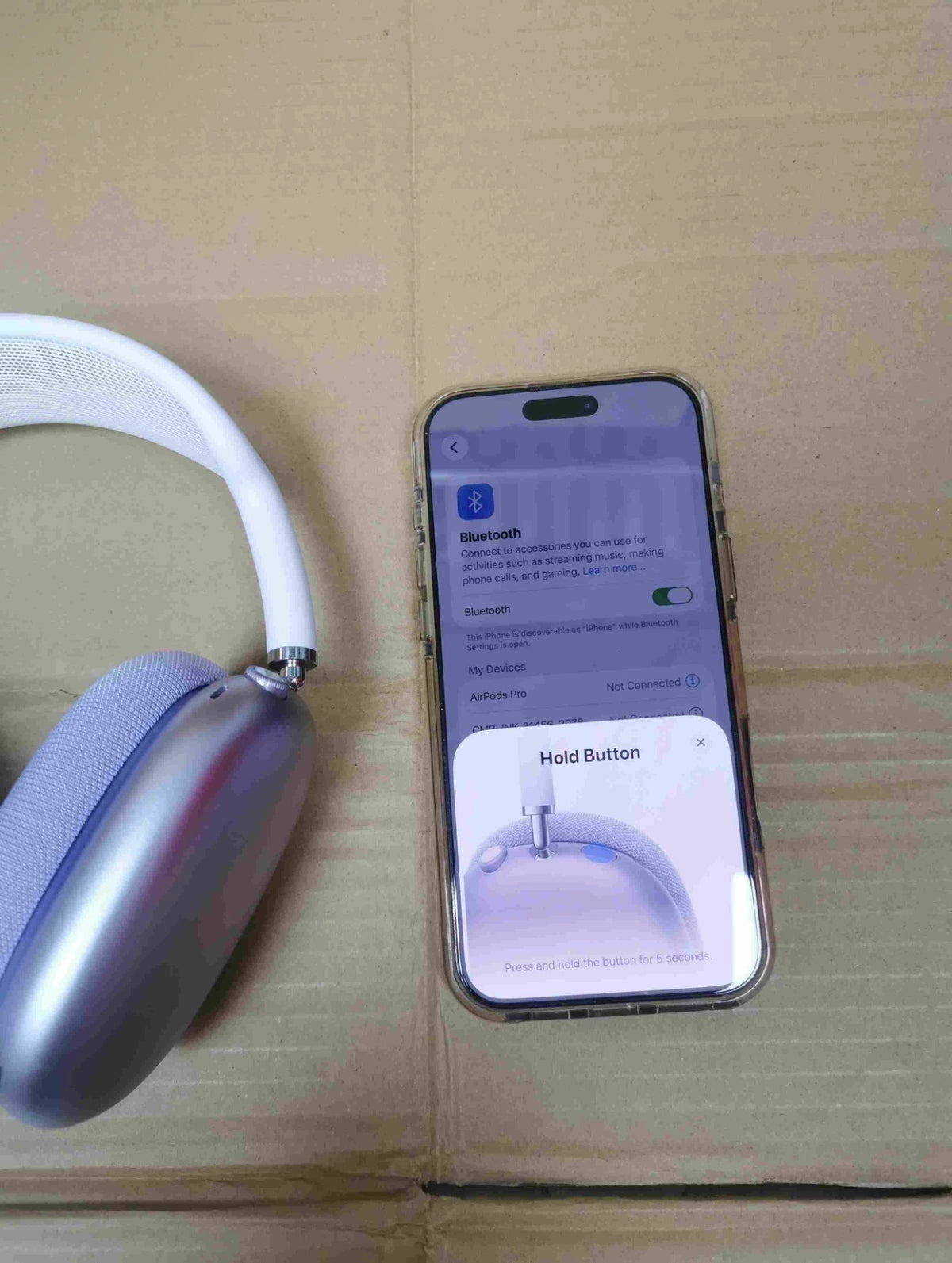 Black AirPods Max headphones and carrying case from the front