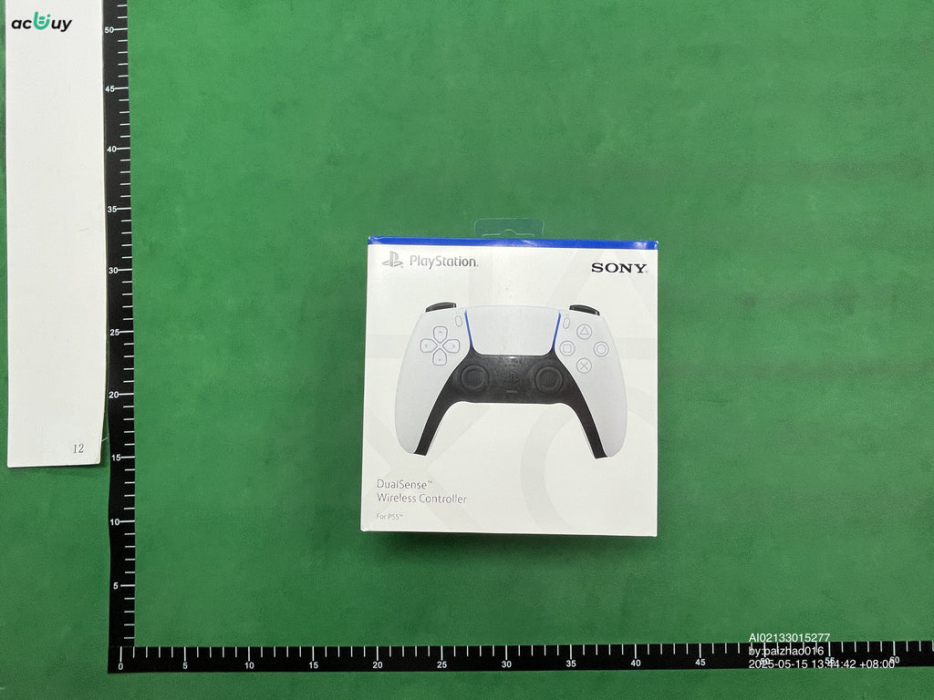 Black PS4 DualShock controller beside its packaging