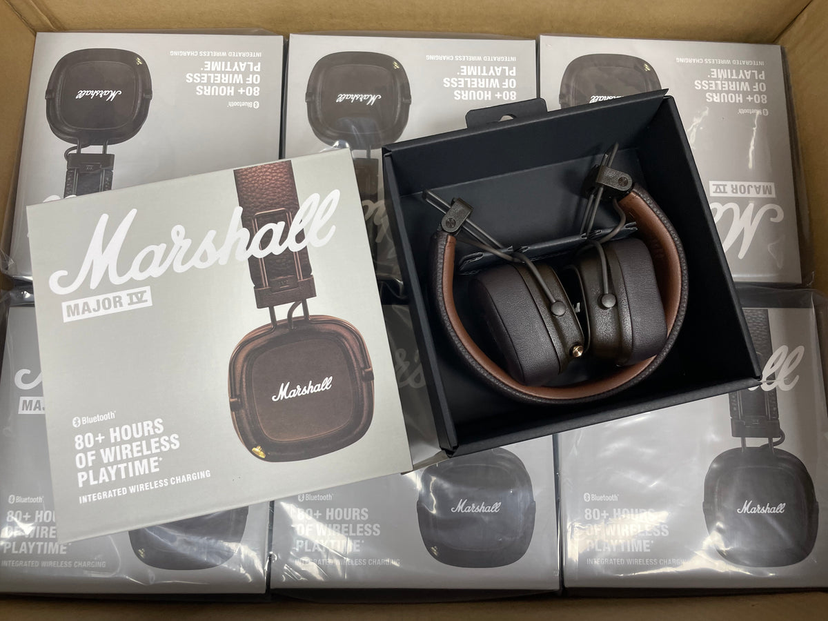 Marshall Major IV wireless headphones held in front of product packaging