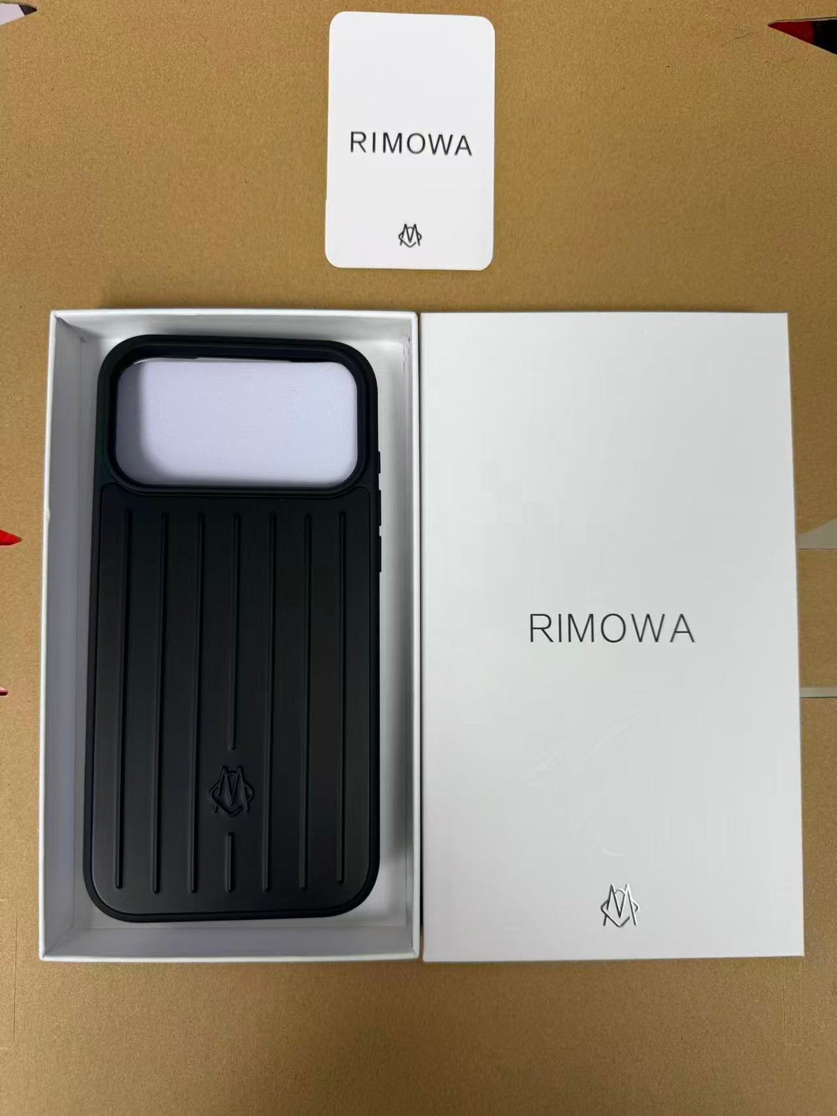 Blue luggage-style iPhone 17 Pro Max case displayed in its box
