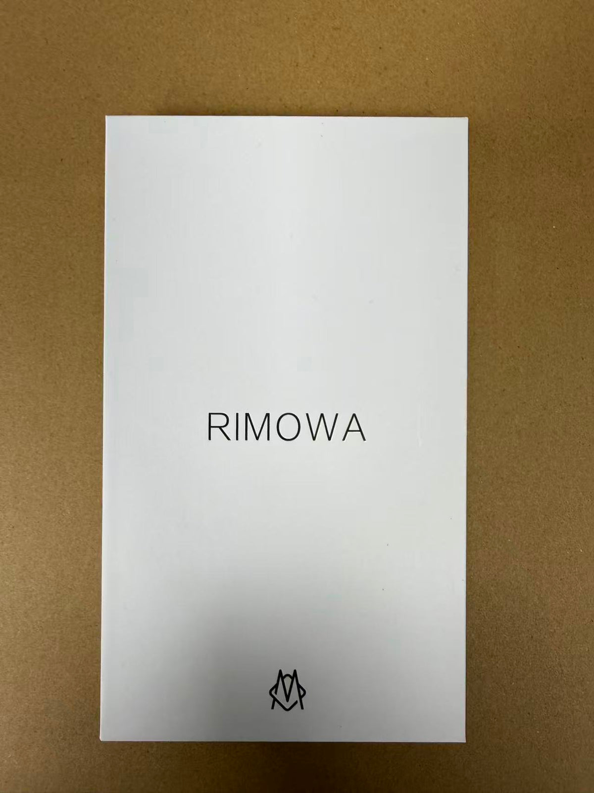 Silver luggage-style iPhone 17 Pro Max case displayed in its box