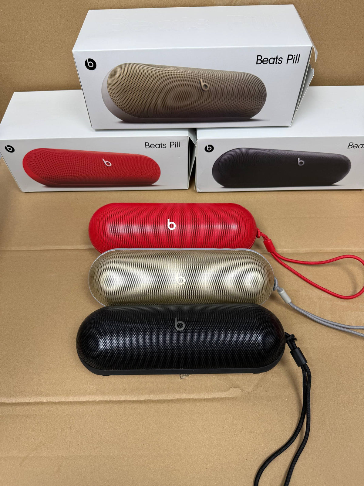 Red Beats Pill portable speaker connected to a smartphone