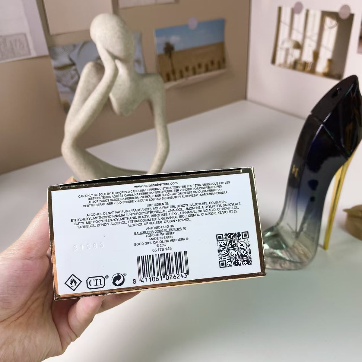 White and gold high heel perfume bottle detail