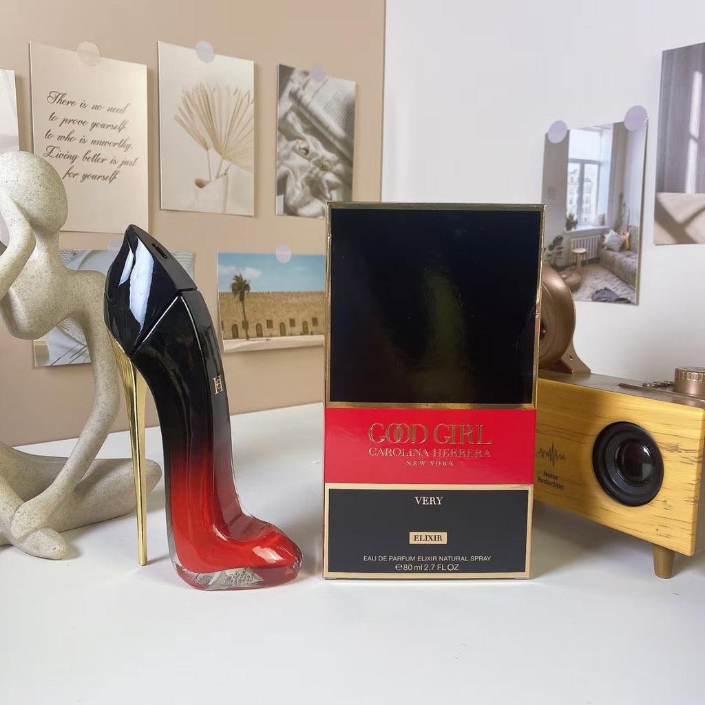Red and black high heel perfume bottle held in hand