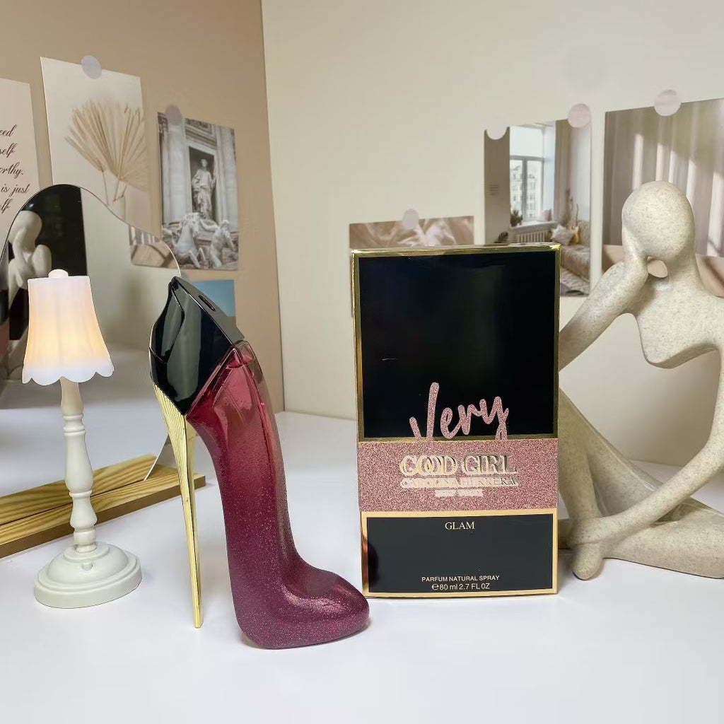 White high heel perfume bottle beside packaging