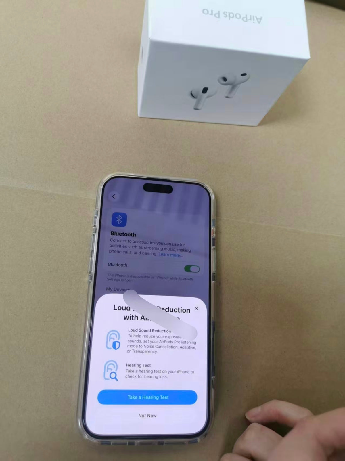 AirPods Pro 3 connected to a phone with listening features