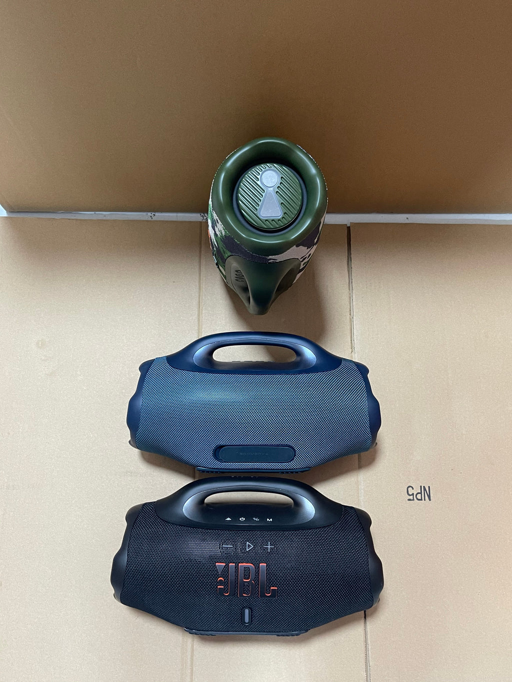 Black JBL Boombox 4 with included accessories and packaging