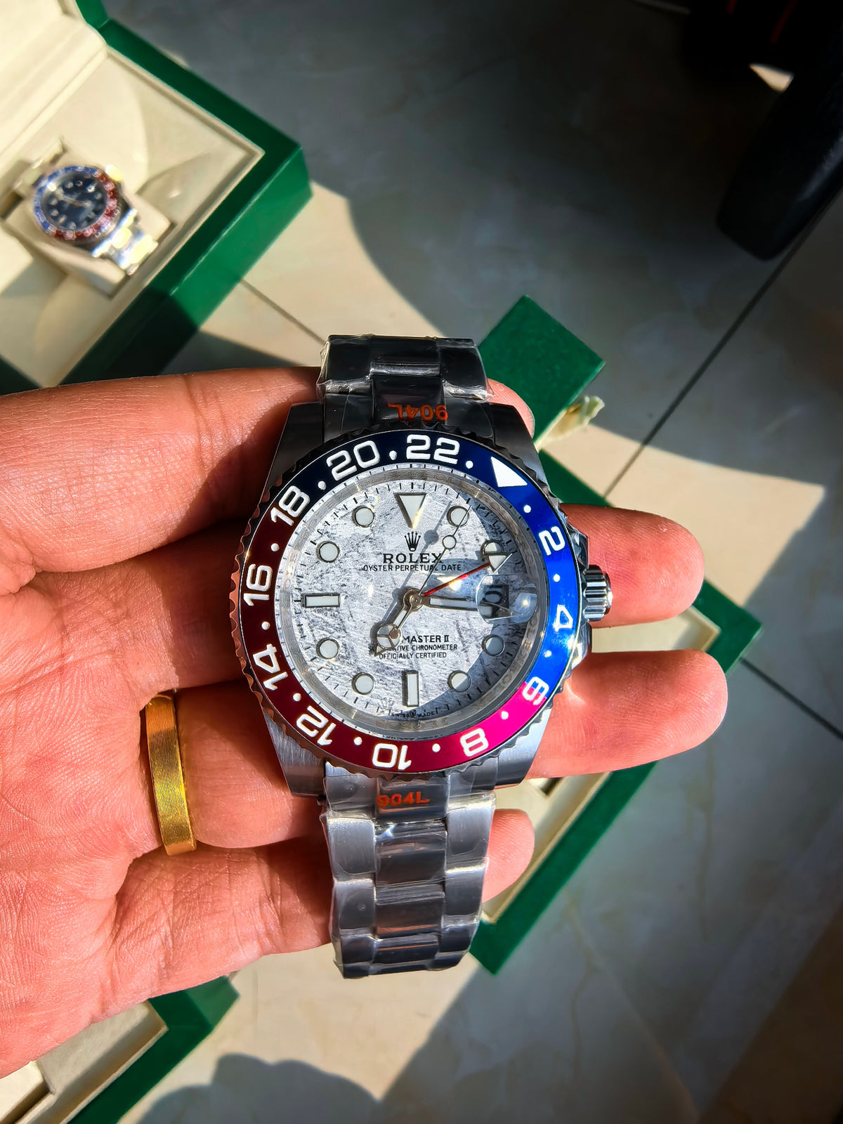 Rolex watch with blue and red bezel