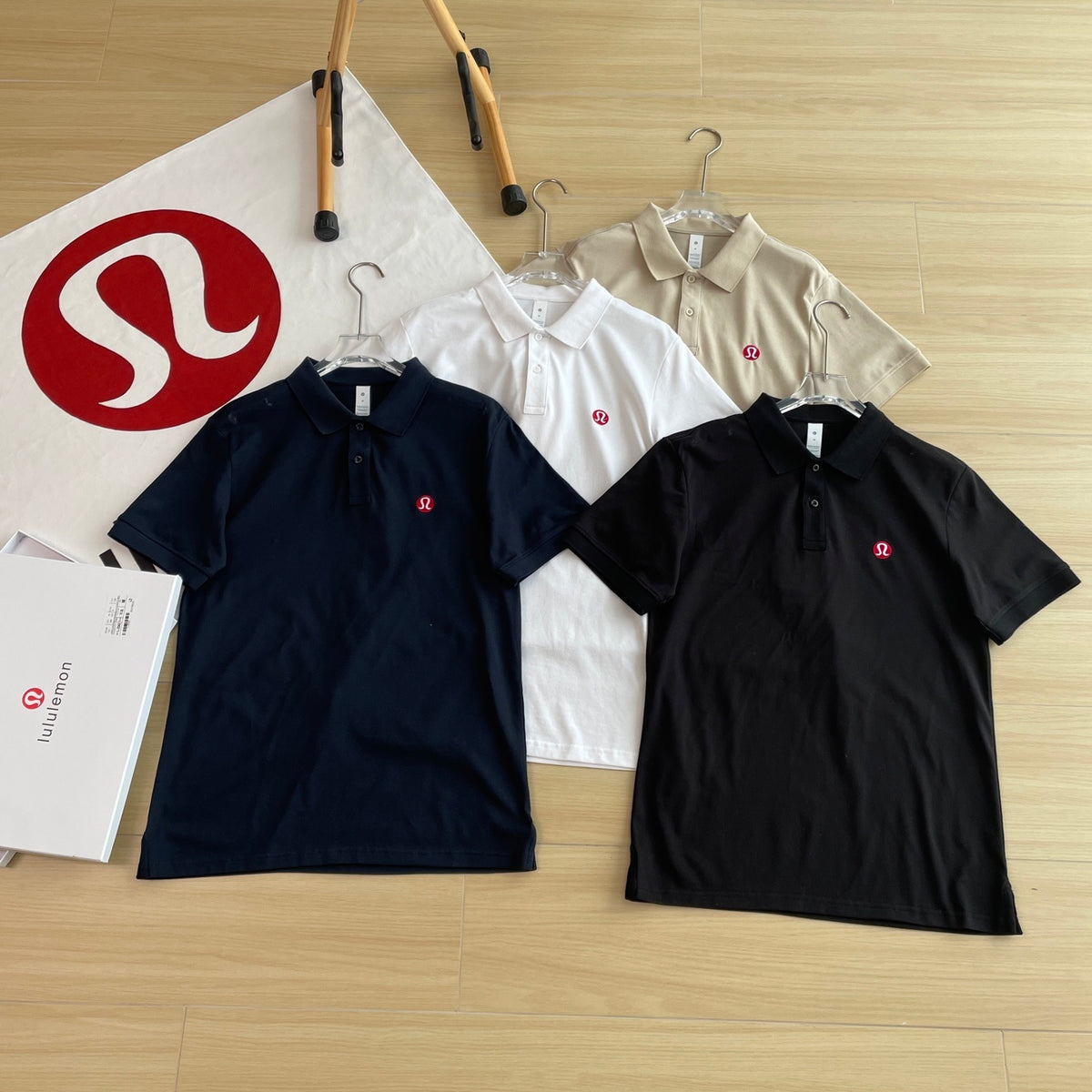 Black Lululemon polo shirt laid flat