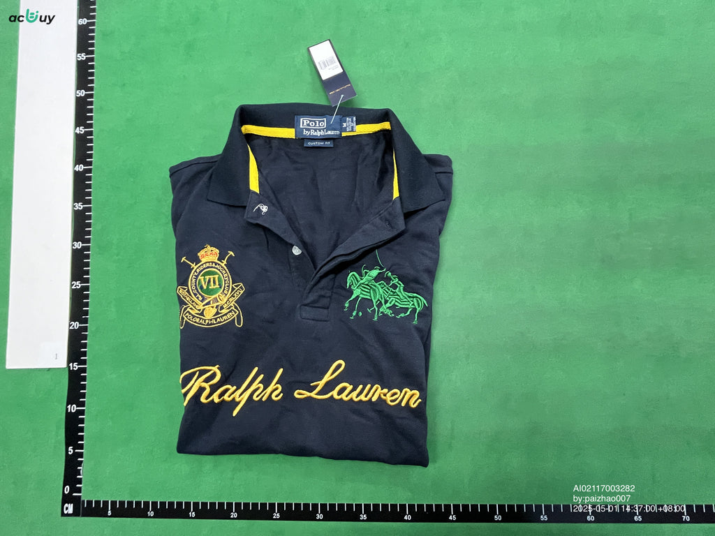 Black embroidered polo shirt folded with size M measurement reference