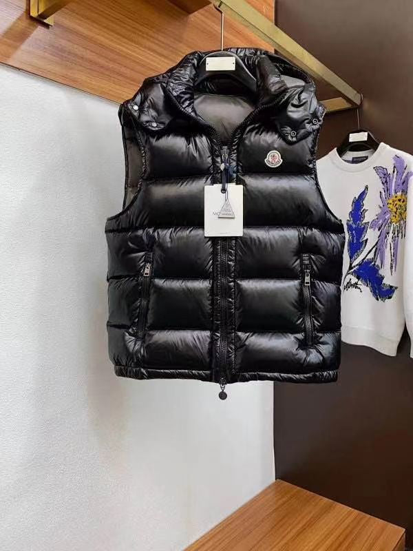 Close-up of zipper pull and logo tag on black puffer vest