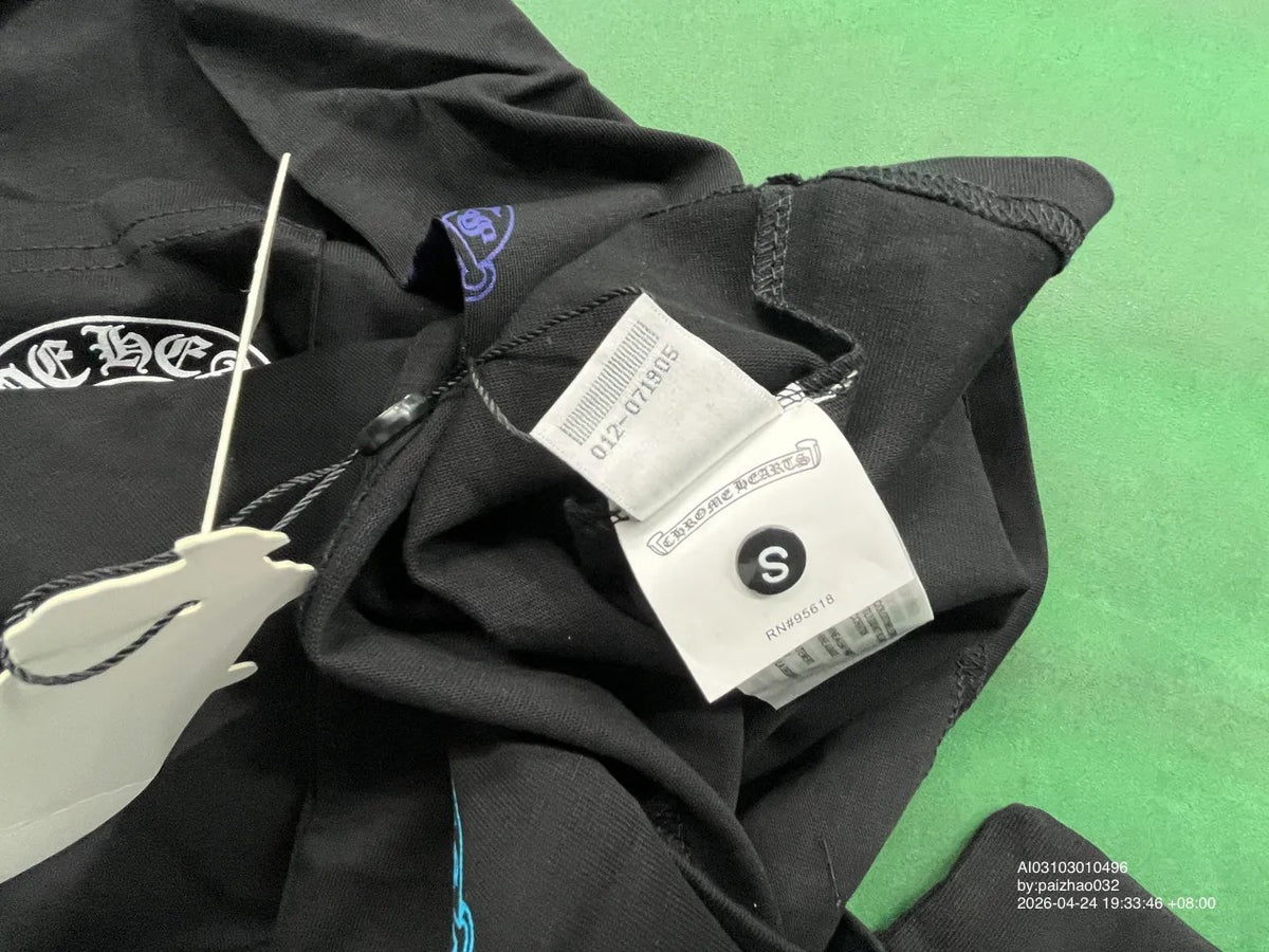 Close-up of black shirt neckline and size label