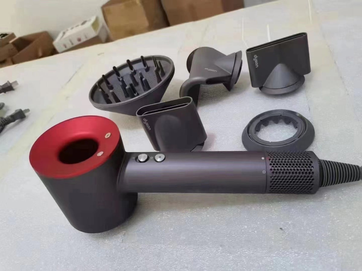 Red Dyson Supersonic HD08 hair dryer with attachments